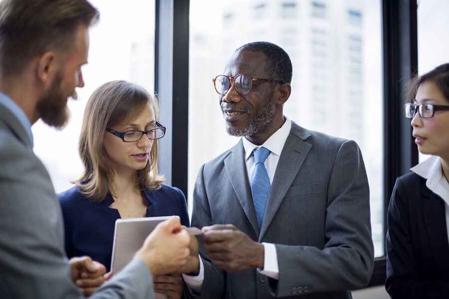 Businessman exchanging business card with colleague