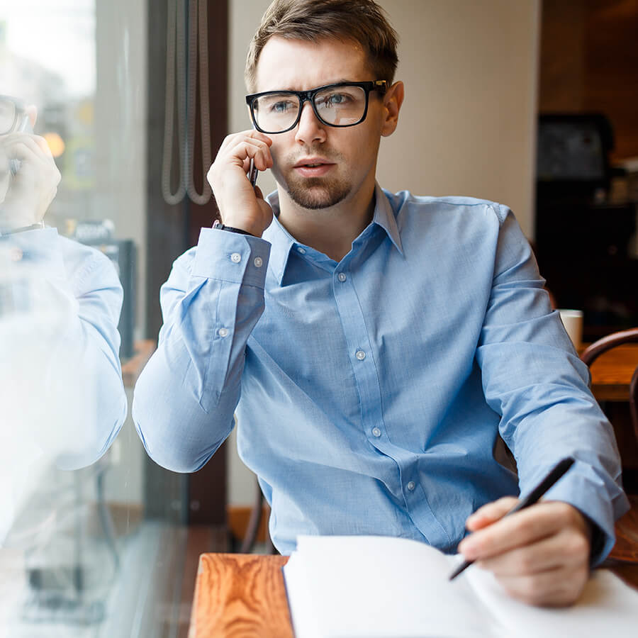 man on phone wearing glasses calling about executive coaching mobile