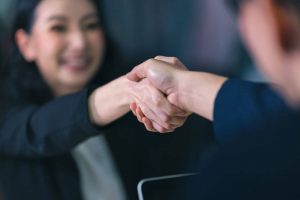 Two people shaking hands when talking about employee retention